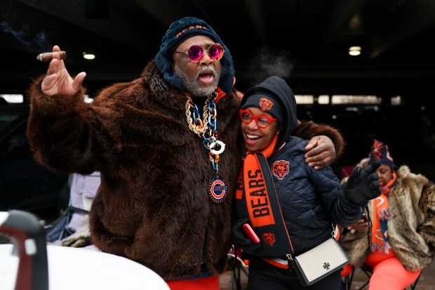 Darrell B., left, and Anitra Smith dance and sing as they tailgate outside of Soldier Field before the Chicago Bears play the Los Angeles Rams in the NFC divisional playoff game on Jan. 18, 2026. (Eileen T. Meslar/Chicago Tribune)