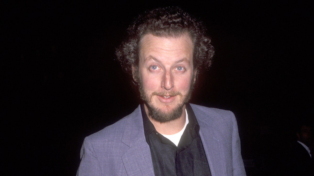 Daniel Stern wears a suit