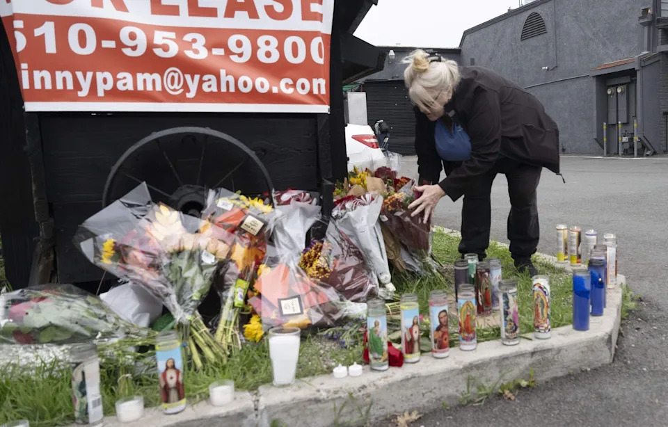 Sacramento Bee/Hector Amezcua - PHOTO: Carolyn Tahod delivers flowers, December 1, 2025, to a memorial outside a banquet hall near Stockton, California, where a mass shooting took place, November 19, 2025.