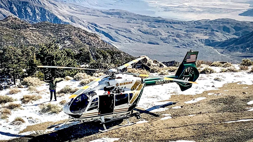 Riverside County Sheriff's Aviation Unit helicopter on mountain with melted snow