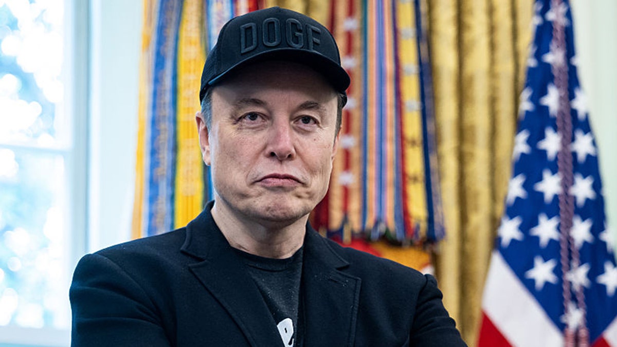 Elon Musk wearing "DOGE" hat