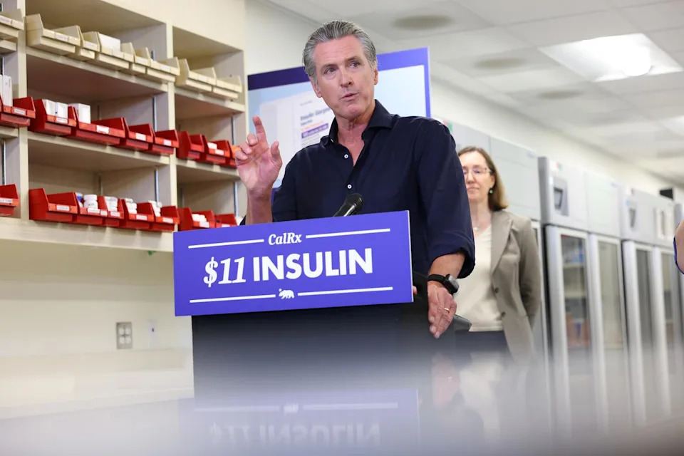 Governor Gavin Newsom speaks at a lecturn that reads $11 insulin
