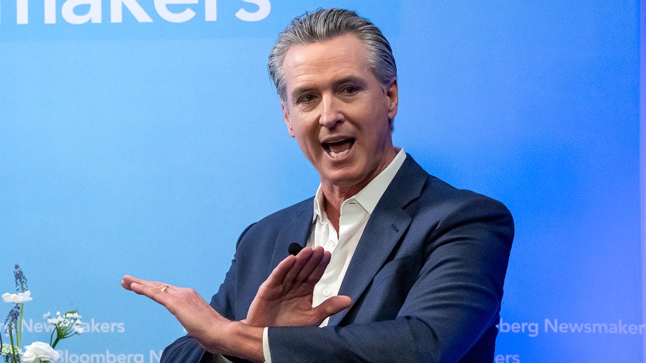 Gavin Newsom crosses hands to make 'X' gesture