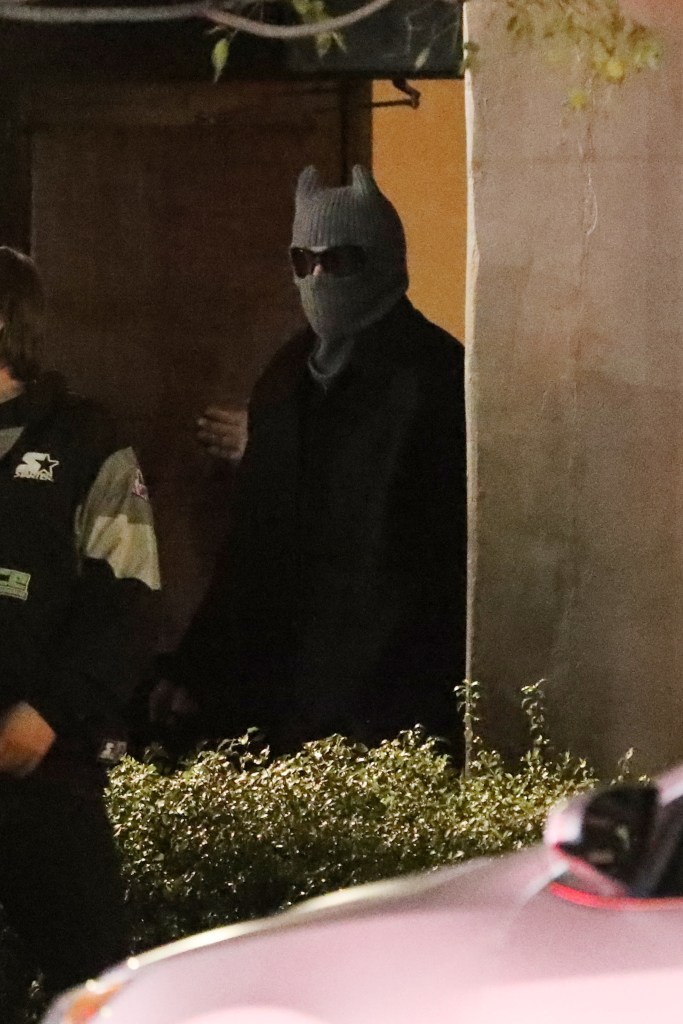 Bad Bunny in a horned beanie and dark sunglasses at night.