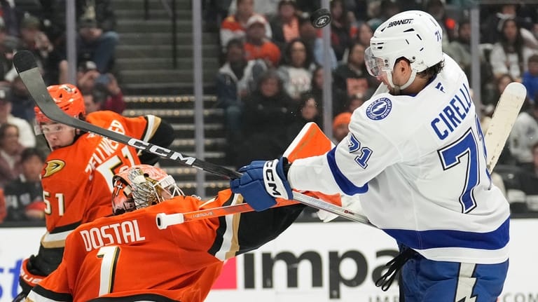 Anaheim Ducks goaltender Lukas Dostal, center, deflects a shot as...