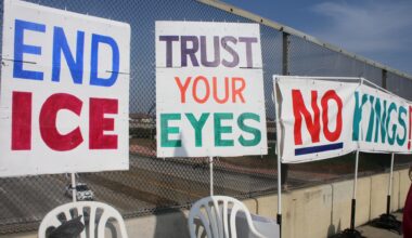 Photo of three signs displayed against the overpass on the Shaw Avenue bridge overpass on Jan. 30.