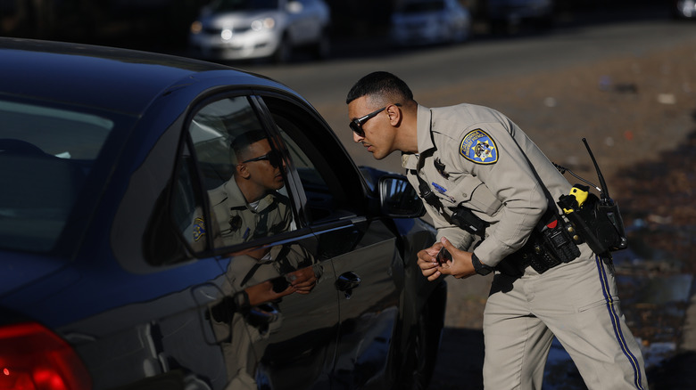 A CHP police officer talks to the driver of a stopped car