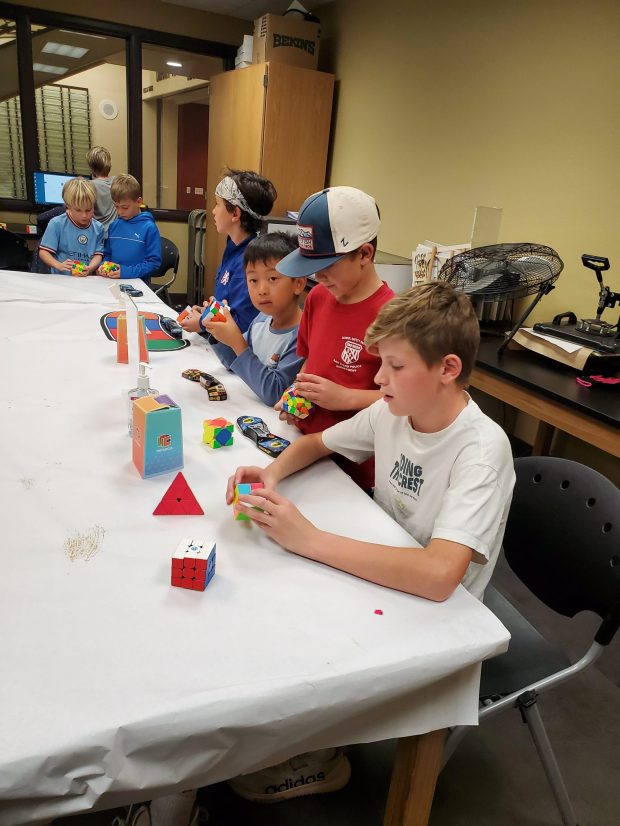 Local kids practice puzzle cubes at the La Jolla/Riford Library. (Ashley Mackin-Solomon)
