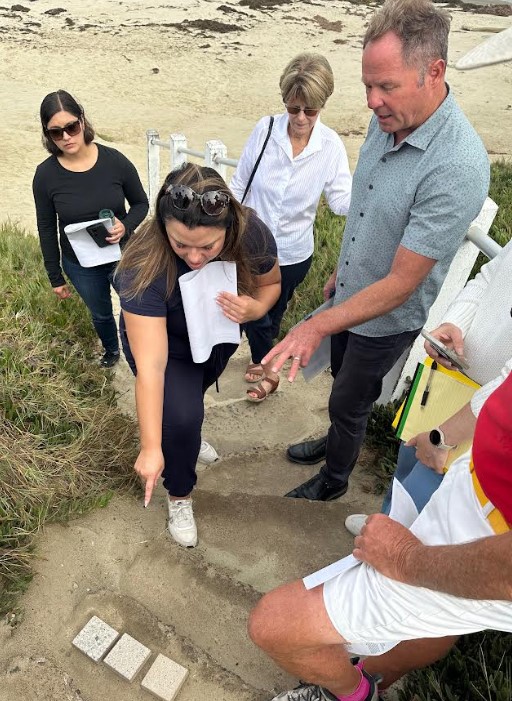 San Diego senior planner Mayra Medel, senior heritage preservation planner Suzanne Segur and La Jolla residents Seonaid McArthur and Jim Neri examine concrete paver samples during a visit to the Whale View Point stairs. (Bob Evans)