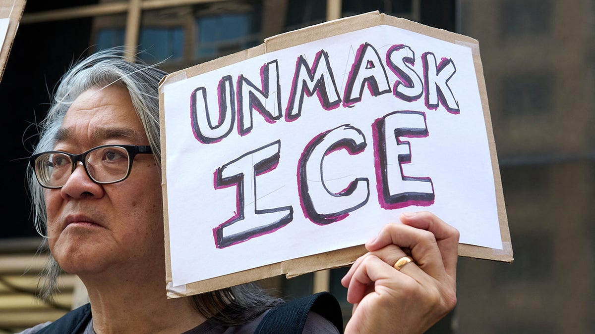 Anti-ICE protesters holds a sign