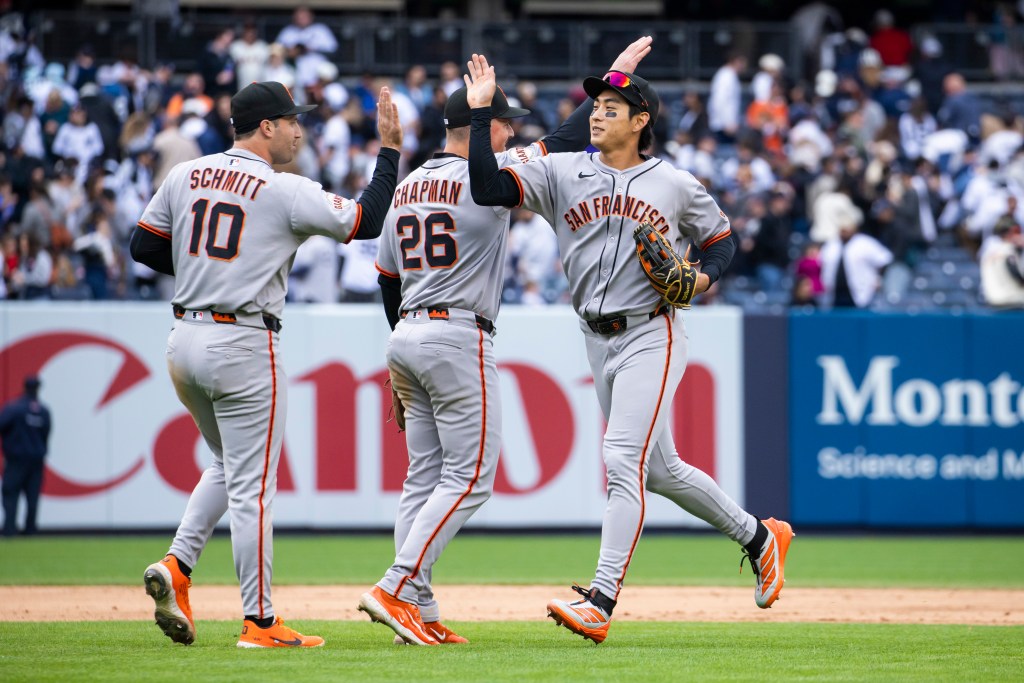 San Francisco Giants players Casey Schmitt (10), Matt Chapman (26), and Jung Hoo Lee celebrate a win.