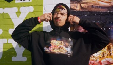 a man pulling the hood of his sweater over his head