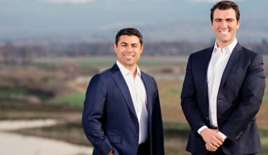 two men in front of a river vista