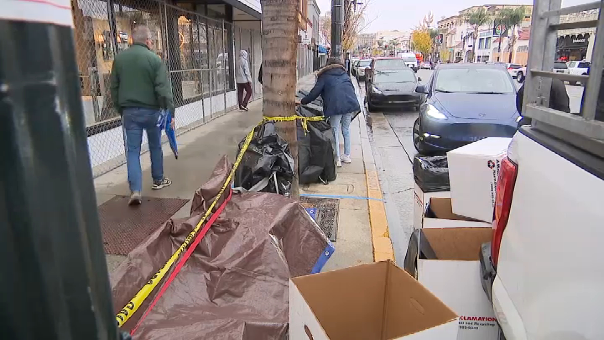 Seats that save spots for Rose Parade spectators are covered with tarp.