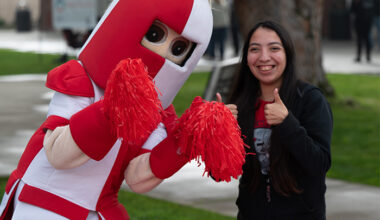 Ronnie Renegade and staff member giving thumbs up to the camera