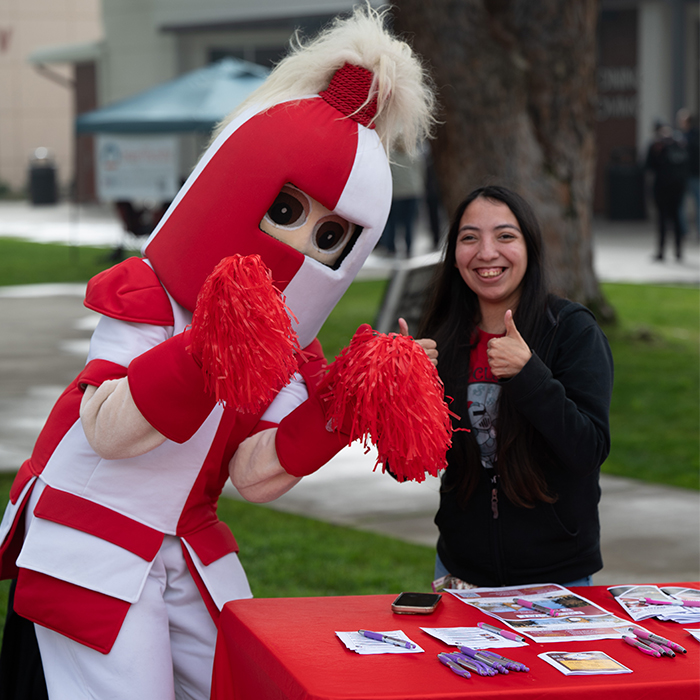 Ronnie Renegade and staff member giving thumbs up to the camera