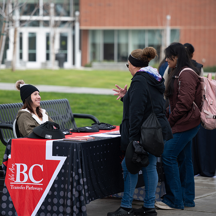 BC students talking to a representative at an information table