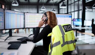 Image of African American police dispatcher talking on the phone