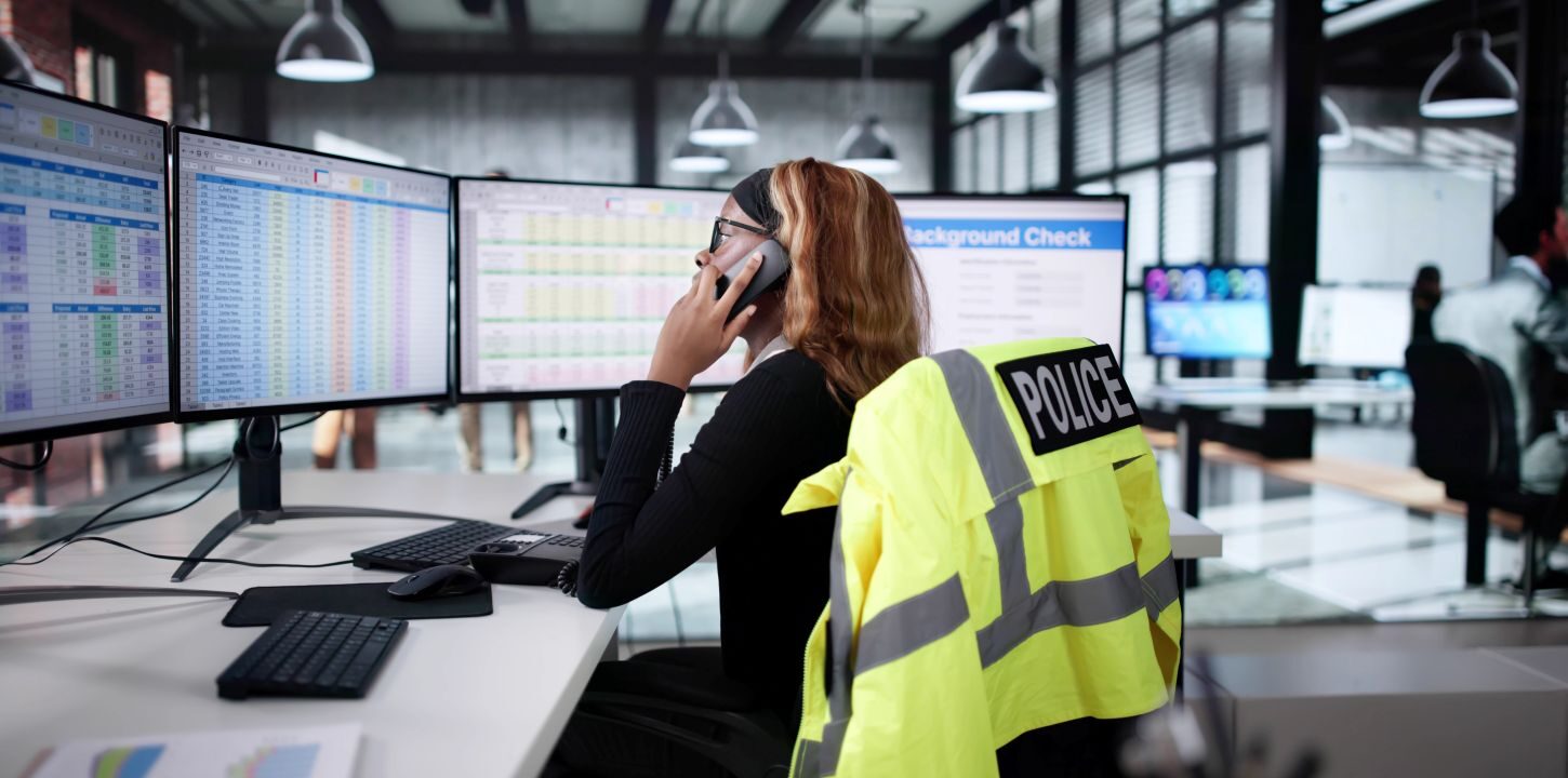 Image of African American police dispatcher talking on the phone