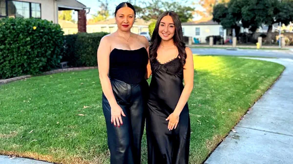 Roxana Rodriguez and Sienna Alfaro smiling in black dresses as they pose for a photo