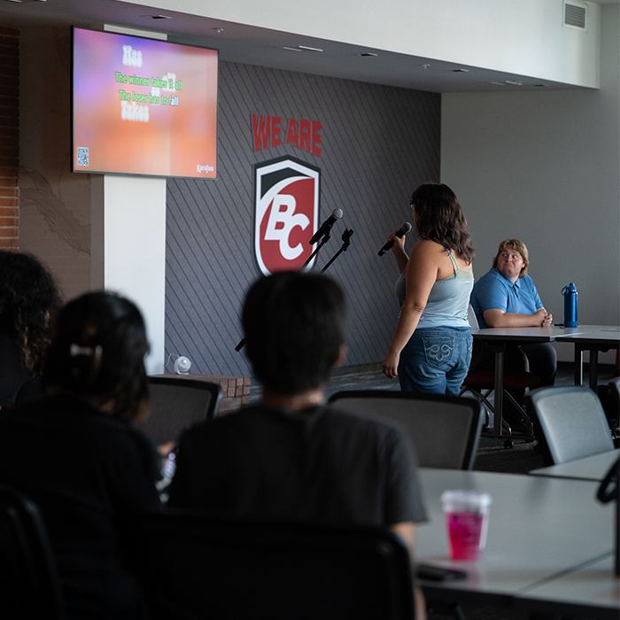 BC student holding microphone during karoake event