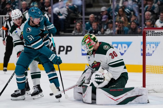 Minnesota Wild goaltender Jesper Wallstedt (30) deflects a shot during the first period of an NHL hockey game against the San Jose Sharks, Wednesday, Dec. 31, 2025, in San Jose, Calif. (AP Photo/Godofredo A. VÃ¡squez)