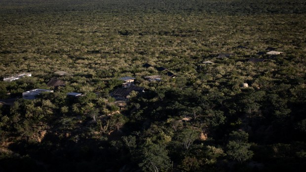Several buildings peek out from thick vegetation at Rancho Cacachilas, an eco-tourism destination owned by Christy Walton in the Sierra de las Cacachilas on Monday, Oct. 27, 2025. The mountain range is about a 40-minute drive outside of La Paz, Baja California Sur. (Ana Ramirez / The San Diego Union-Tribune)