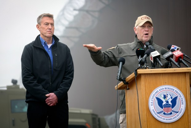 White House "border czar" Tom Homan and U.S. Customs and Border Protection Commissioner Rodney Scott speak during a press conference along the U.S.-Mexico border wall in San Ysidro on Dec. 13. (Sandy Huffaker / For The San Diego Union-Tribune)