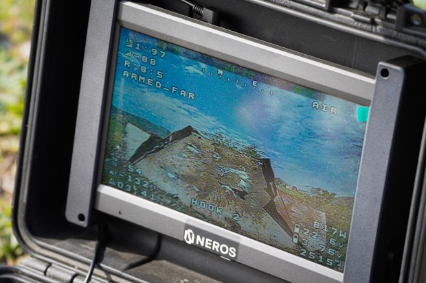 At a live fire range on Camp Pendleton, Marines supporting the drone operation watch the monitor to assist the drone pilot in reaching a target located about a mile from their location.  (Nelvin C. Cepeda / The San Diego Union-Tribune)