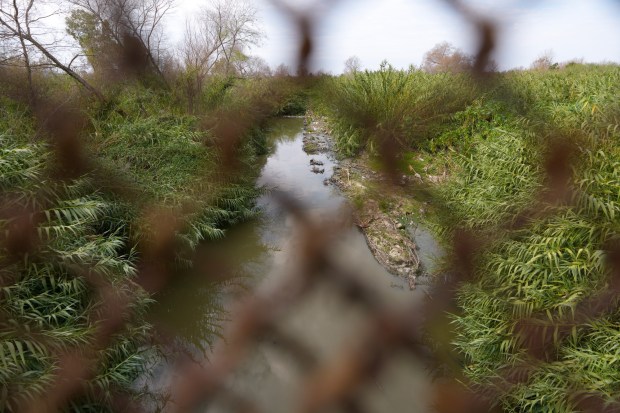 One of the streams in the Tijuana River Valley that flows beneath the bridge on Dairy Mart Road, located along the U.S.-Mexico border in San Diego, CA. (Nelvin C. Cepeda / The San Diego Union-Tribune)