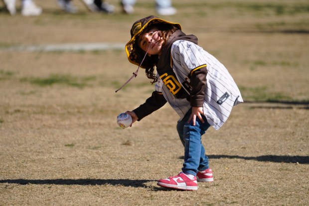 Allison Borjon, 4, fielded a ball while playing with her mother, Valerie Montoya of Southcrest, in centerfield at Petco Park. The two were among the thousands that arrived at Petco Park for FanFest on Saturday, Feb. 1, 2025, in San Diego, CA.  (Nelvin C. Cepeda / The San Diego Union-Tribune)