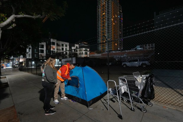 Early Thursday morning in downtown East Village, Demian Williams and Brittany Barrett were among the volunteers taking part in the annual Point-in-Time Count of people experiencing homelessness in San Diego County. (Nelvin C. Cepeda / The San Diego Union-Tribune)