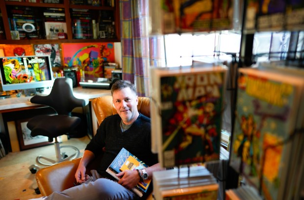 Ryall is surrounded by comic books in his studio at his Scripps Ranch home on Dec. 17, 2025. (Nelvin C. Cepeda / The San Diego Union-Tribune)