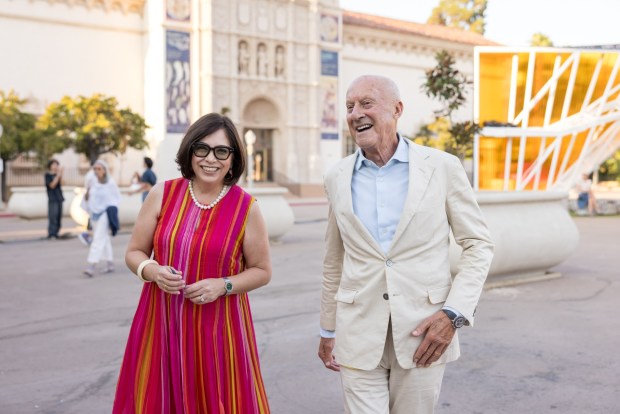 San Diego Museum of Art Executive Director Roxana Velazquez, left, and Foster+Partners founder Lord Norman Foster walk through Balboa Park on Sept. 9, 2024. Foster+Partners is designing the museum's new west wing. (Bauman Photographers)