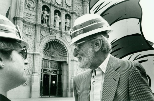 Children's author and illustrator Theodore "Ted" Geisel at the installation of a promotional Cat in the Hat cornice piece that was added to the facade of the San Diego Museum of Art in 1986. (SDMA Archives)