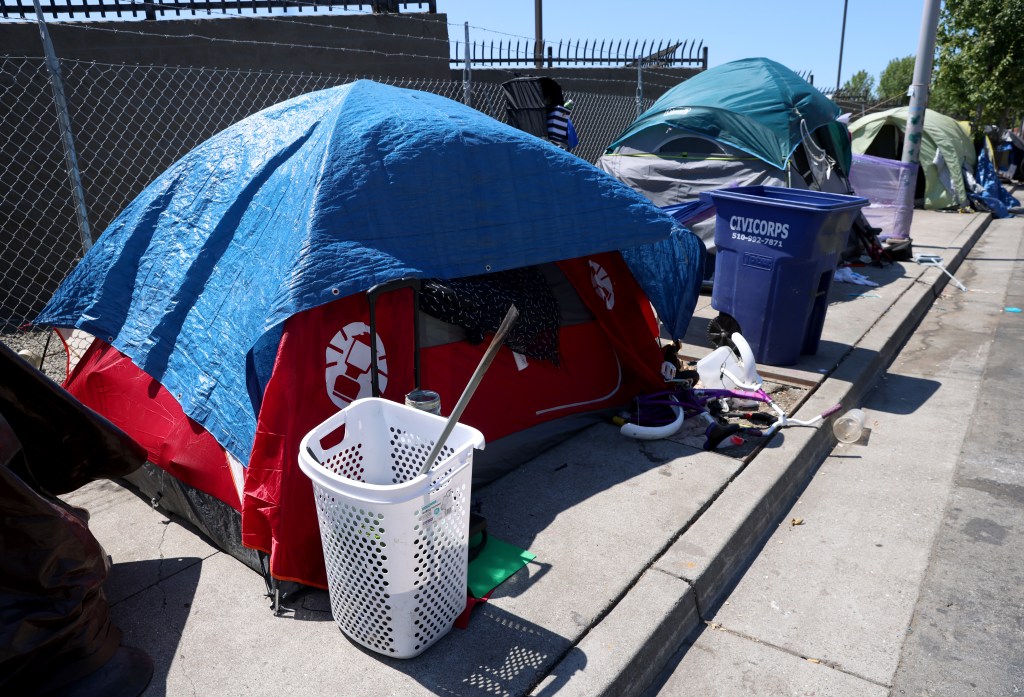 Tents line a street at a homeless encampment.