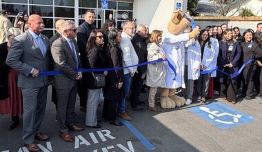 lineup of people at a ribbon cutting