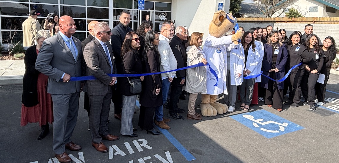 lineup of people at a ribbon cutting