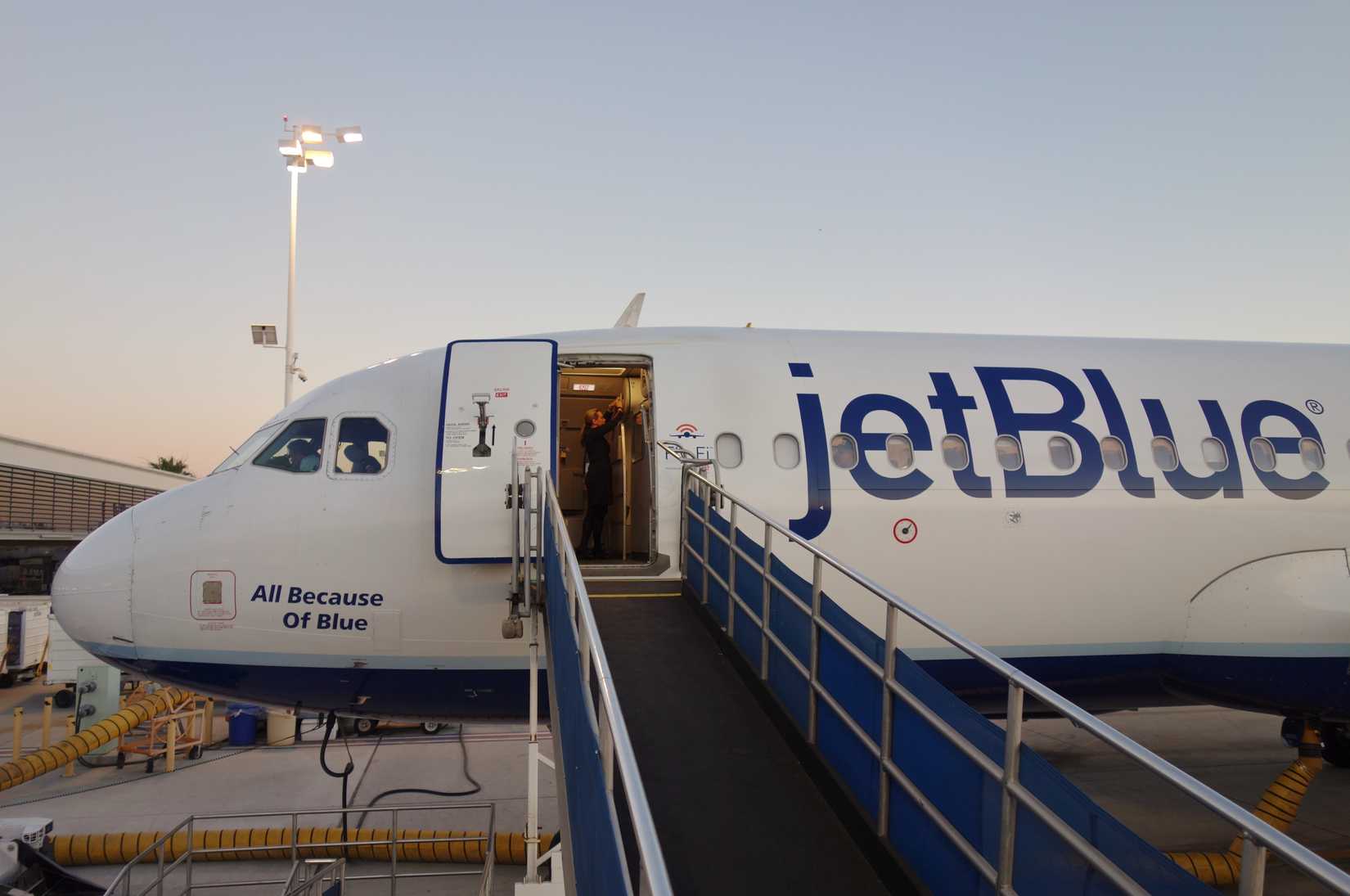 View of a JetBlue (B6) airplane on the tarmac at sunset at the Long Beach Airport (LGB), formerly Daugherty Field, a focus city for JetBlue Airways.