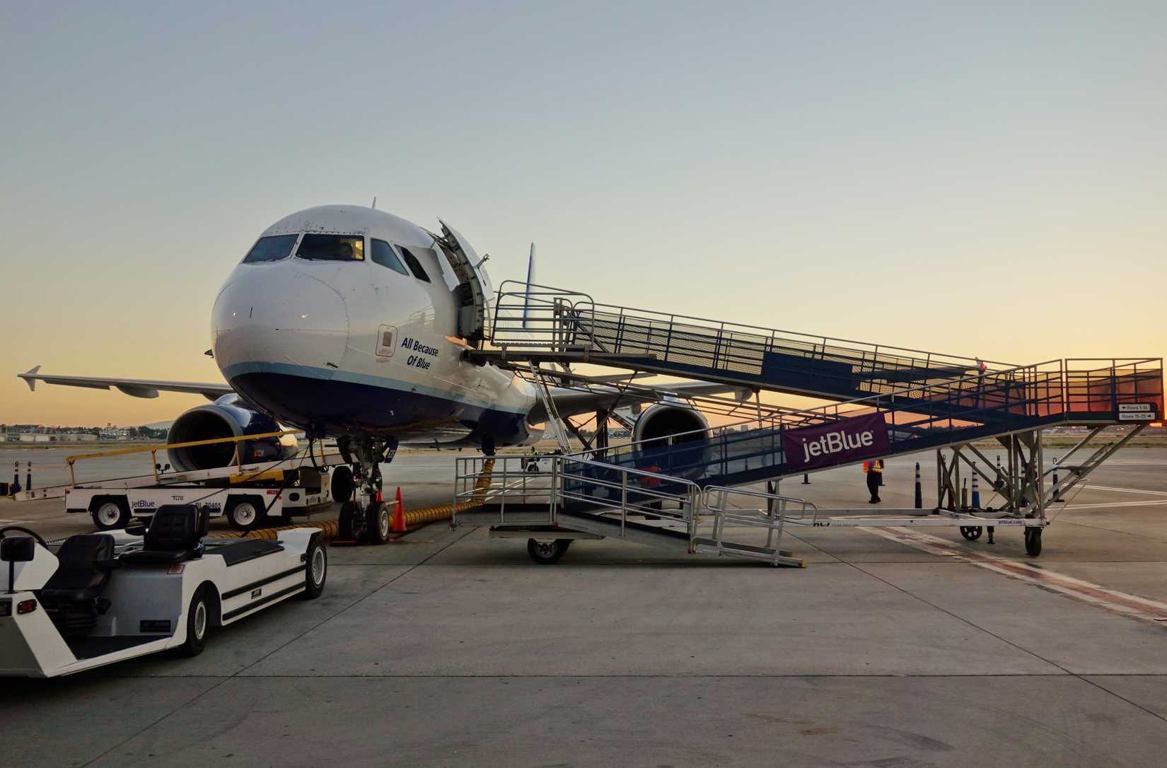 View of a JetBlue (B6) airplane on the tarmac at sunset at the Long Beach Airport (LGB).
