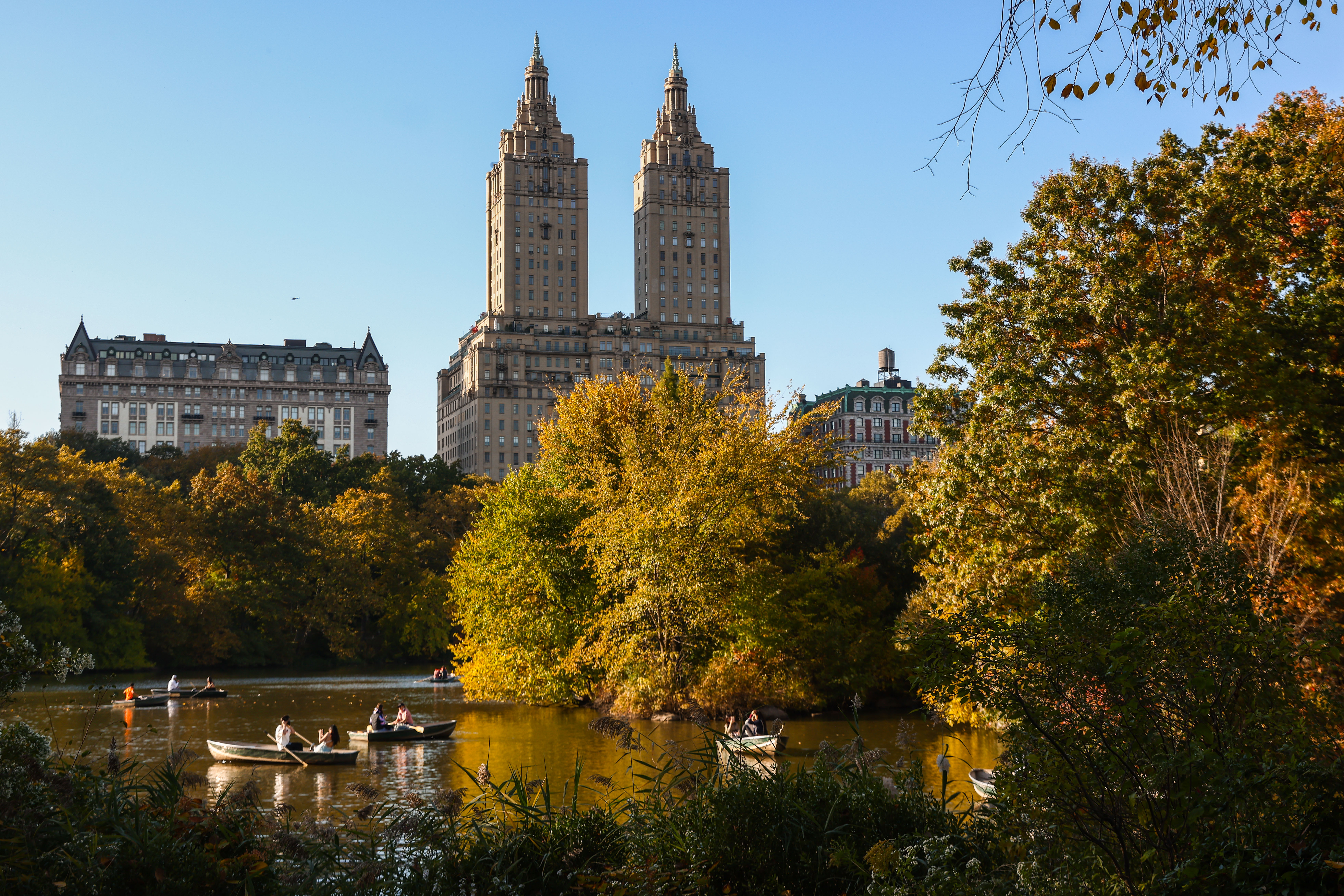 The San Remo building and boats on The Lake during autumn in Central Park, New York.