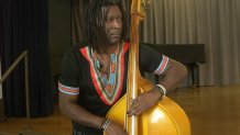 Bass player and composer Marcus Shelby plays an upright bass in the auditorium of San Francisco’s Community Music Center.
