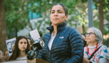 Dr. Aisha Wahab outside, at podium