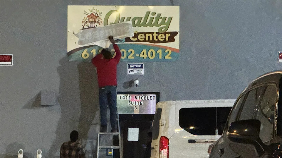 Quality Learning Center sign being fixed