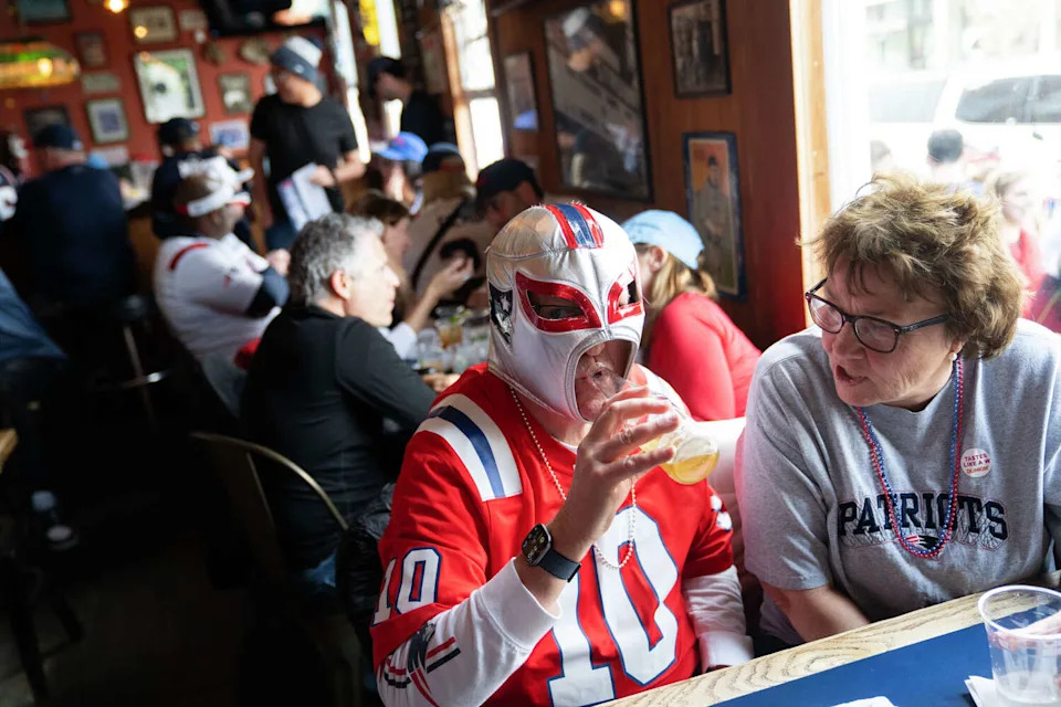 Jim Bransfield dons a Patriot-themed wrestling mask at Connecticut Yankee before Super Bowl LX in San Francisco on Sunday. (Minh Connors/For the S.F. Chronicle)