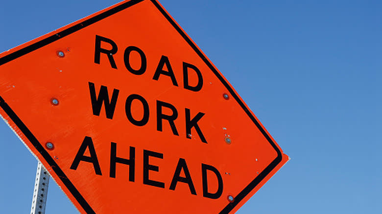 a Road Work Ahead orange sign