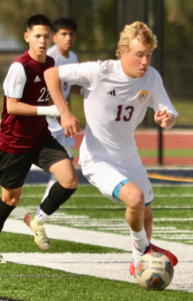 Senior Pointer soccer player Logan Aldrich battles a Calexico defender for possession during a match between the schools. (Photo by Scott Hopkins/Special for Times of San Diego)