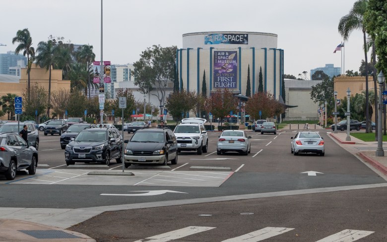 A car drives through the parking lot for the Air and Space Museum in Balboa Park.