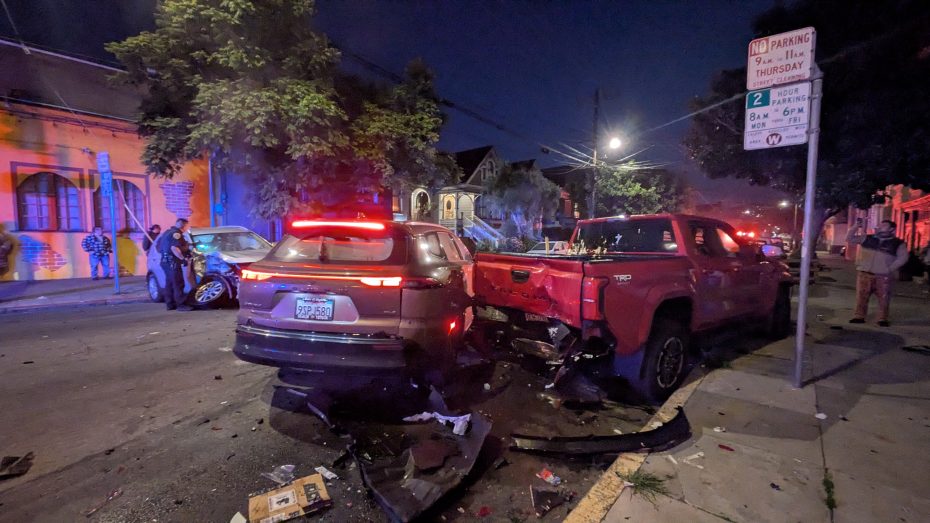 Several vehicles appear damaged from a nighttime collision on a city street, with debris scattered on the road and emergency lights visible in the background. Feb. 3, 2026