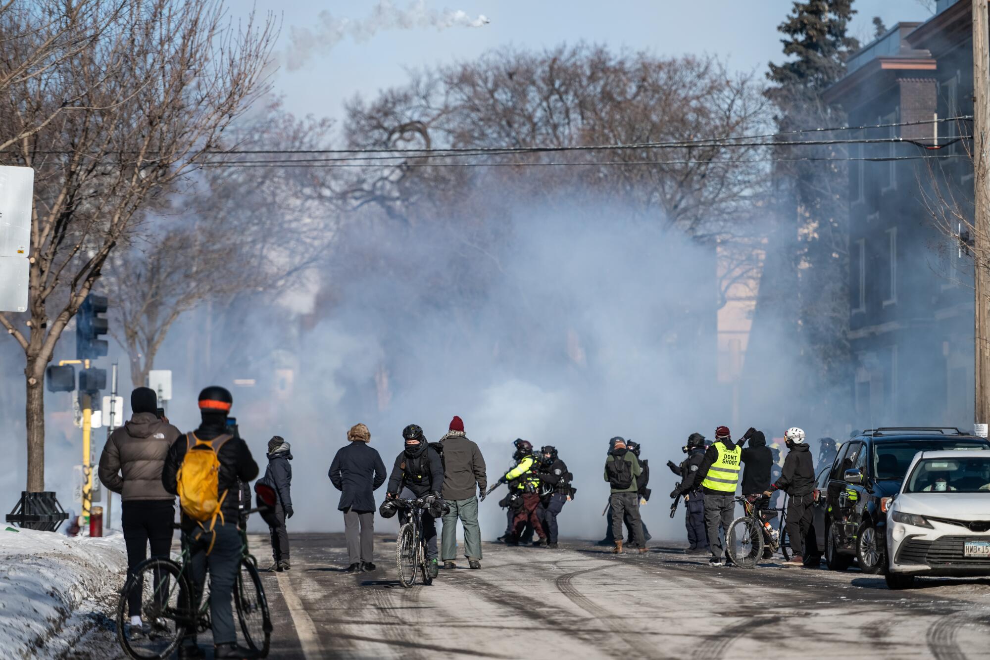 Law enforcement officers launch tear gas canisters in Minneapolis on Jan. 24.
